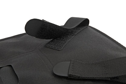 Black tactical vest with straps on a white background